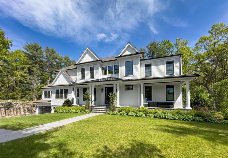 Large contemporary farmhouse style suburban home on a sunny spring morning